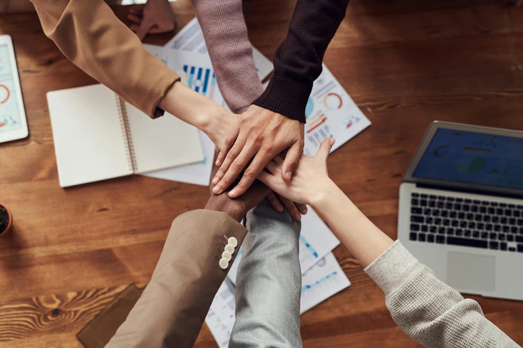 teamwork collaboration hands stack in office meeting representing partnership and business unity